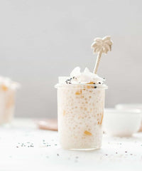 Glass of creamy slow cooked rice pudding topped with cinnamon, from Modern Slow Cooker