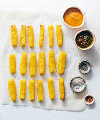 Tray of golden polenta chips with a dipping sauce, from Modern Slow Cooker