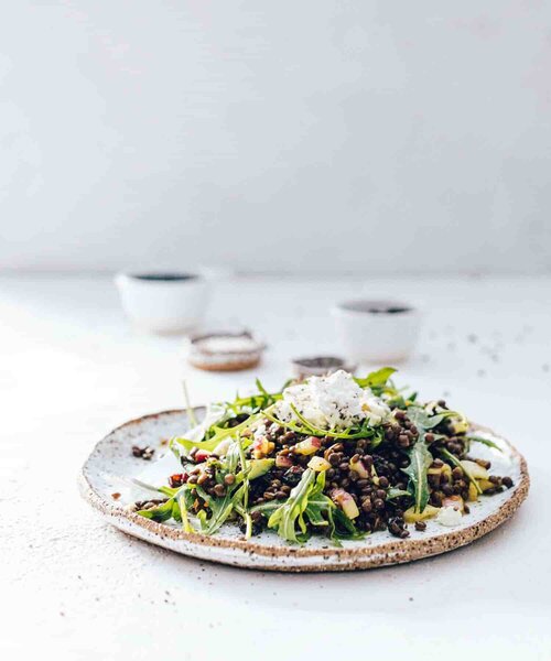 Platter of slow cooked greens and salad scattered with seeds, from Modern Slow Cooker