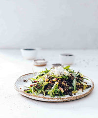 Platter of slow cooked greens and salad scattered with seeds, from Modern Slow Cooker