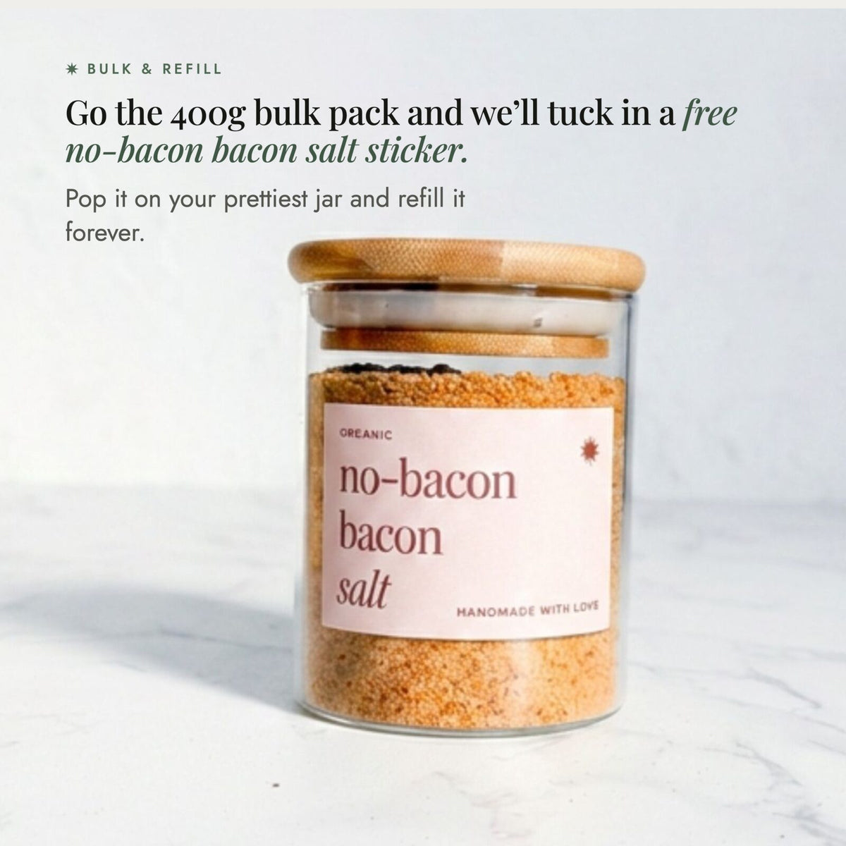 Glass jar of No-Bacon Bacon Salt with a bamboo lid; go the 400g bulk pack and a free No-Bacon Bacon Salt sticker is tucked in, so you can pop it on your prettiest jar and refill it forever