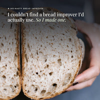 Hands holding a sourdough loaf of bread cut in half to show its open crumb; I couldn't find a bread improver I'd actually use, so I made one, the No-Nasty Bread Improver