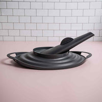 OmniSteam Lid resting on a pink surface with its steam spout attached