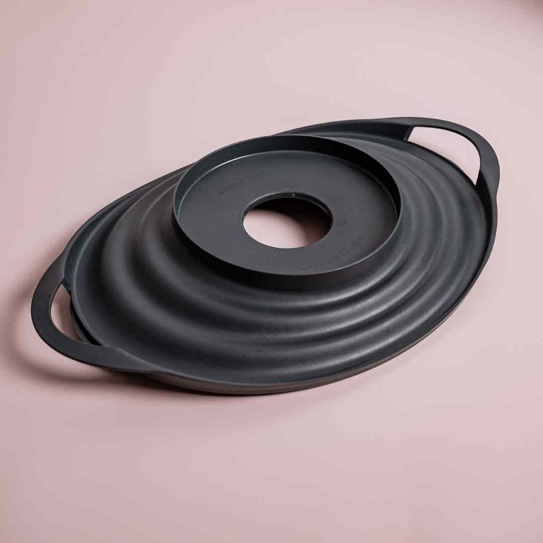 OmniSteam Lid shown at an angle to display its shape and side handles