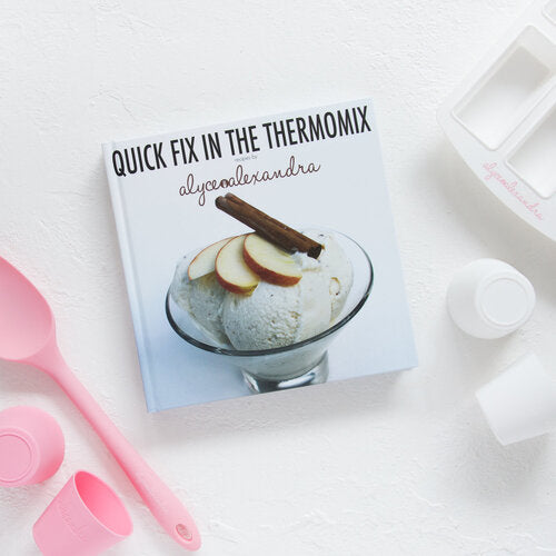Cover of Quick Fix in the Thermomix by Alyce Alexandra, styled with a poached pear dessert and pink measuring spoons