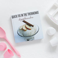 Cover of Quick Fix in the Thermomix by Alyce Alexandra, styled with a poached pear dessert and pink measuring spoons