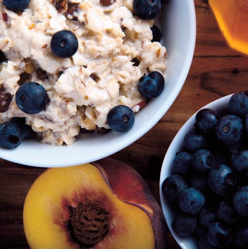 Bowl of overnight oats with blueberries and peaches, from Quick Fix in the Thermomix
