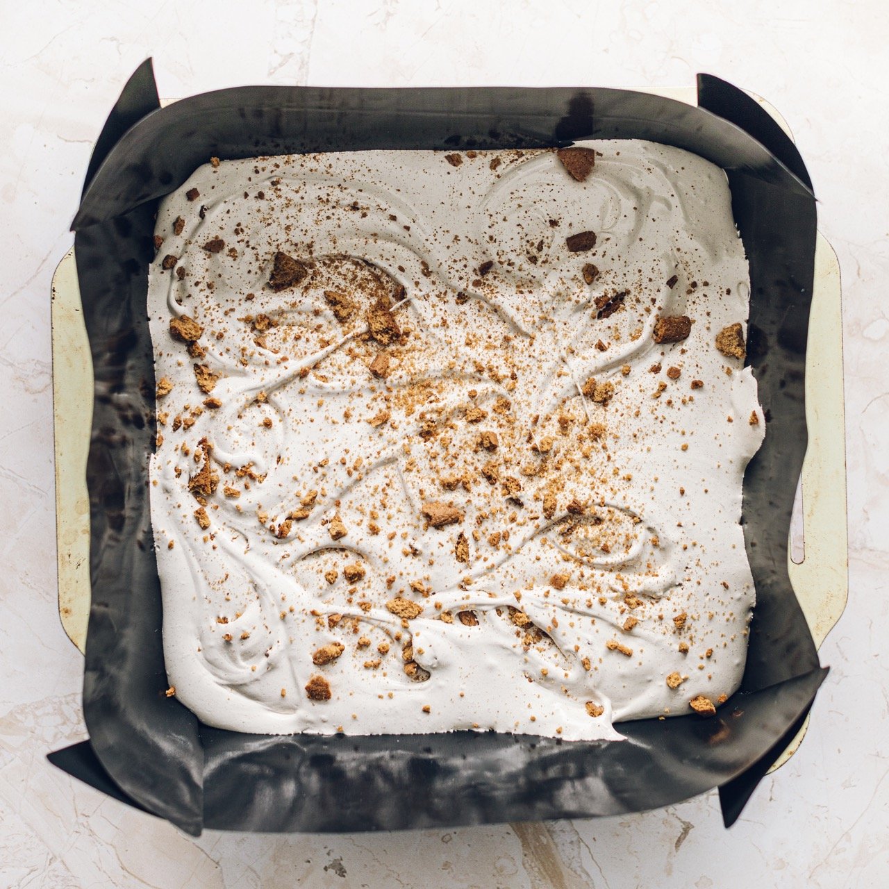 Reusable square cake tin liner in a tin