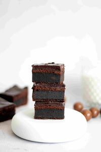 Stack of chocolate layer cake squares, baked using the Reusable Square Cake Tin Liner