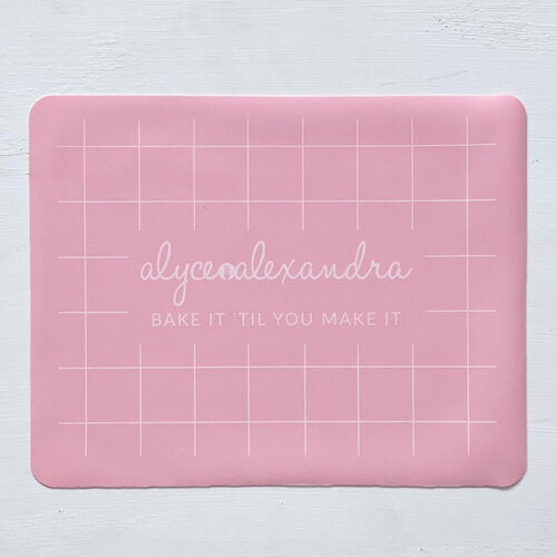 Pink Silicone Baking Mat laid flat, showing its grid guide lines