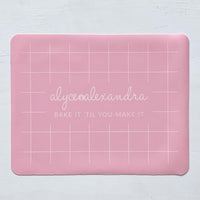 Pink Silicone Baking Mat laid flat, showing its grid guide lines