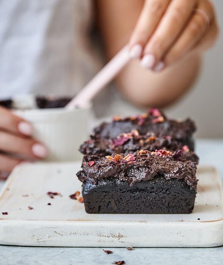 Hands decorating a chocolate and berry loaf made in the Silicone Bar Moulds