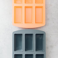 Terracotta and grey Silicone Bar Moulds trays overlapping to show both colours