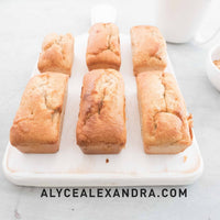 Three golden mini loaves turned out of the Silicone Bar Moulds onto a marble board