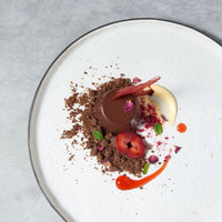 Plated chocolate dessert with soil and fruit, made in the Silicone Dariole Moulds
