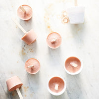 Set desserts turned out onto a bench beside empty Silicone Dariole Moulds