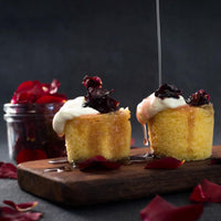 Sticky puddings with cream and berries on a dark board, made in the Silicone Dariole Moulds