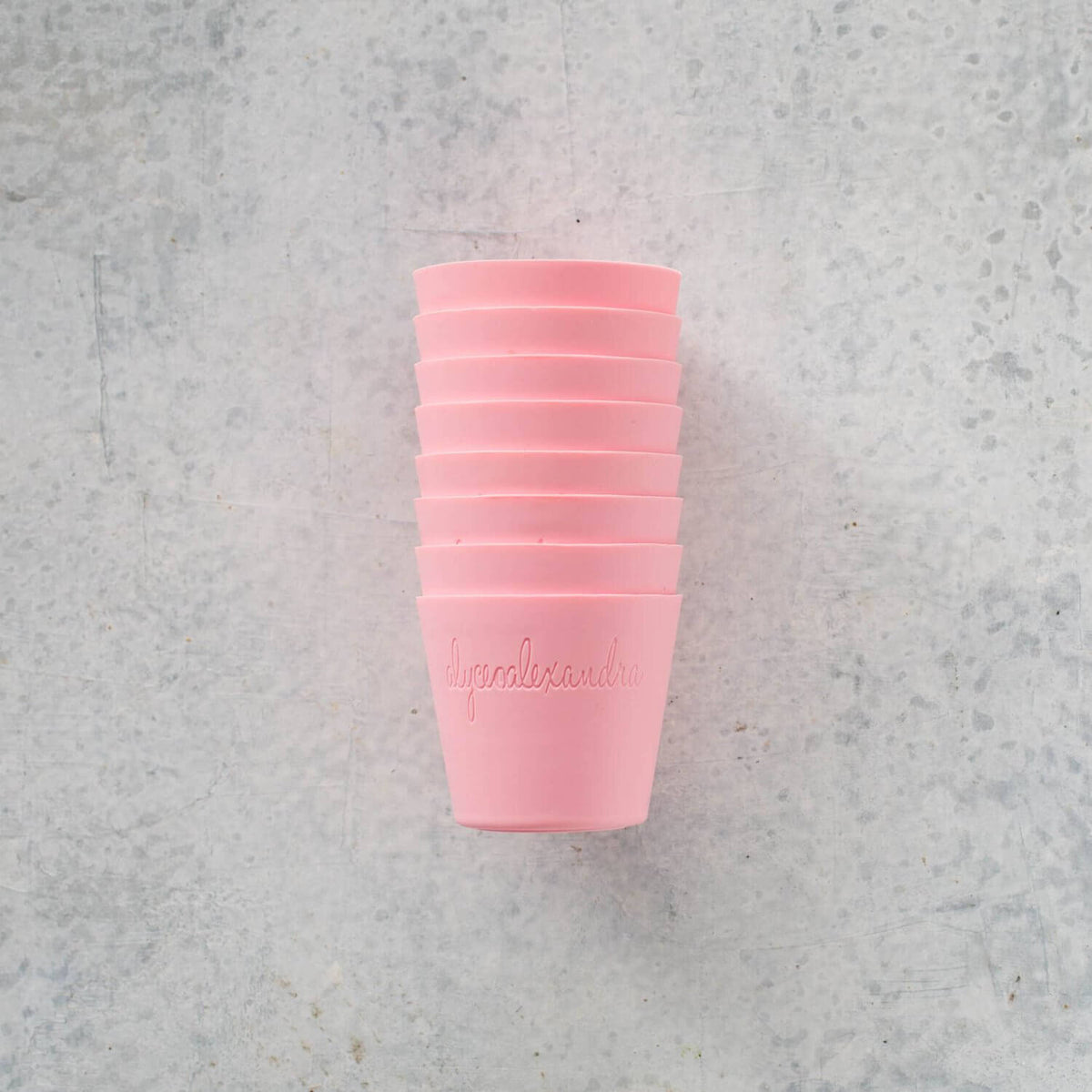 Stack of pink Silicone Dariole Moulds on a pale bench