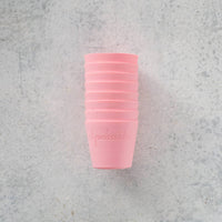 Stack of pink Silicone Dariole Moulds on a pale bench