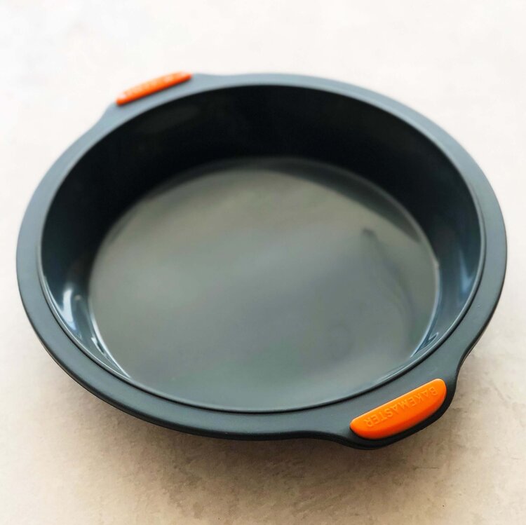 Charcoal Silicone Round Pan with orange grips, shown from above