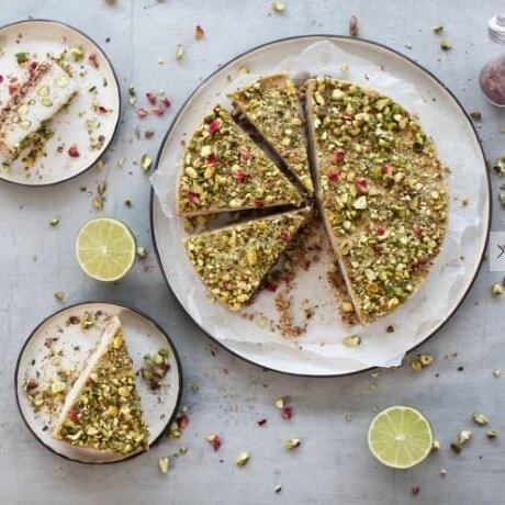 Pistachio and lime cake cut into wedges on a plate, baked in the Silicone Round Pan