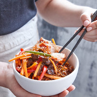 Bowl of noodles with beef and vegetables served with chopsticks, steamed using the Silicone Steaming Mat