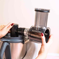 Hands fitting the Slicer and Shredder onto the WunderCentix axis on a Thermomix