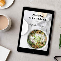 Slow Cooker Recipes with Thermomix-Prep Options digital cookbook shown on a tablet beside a coffee