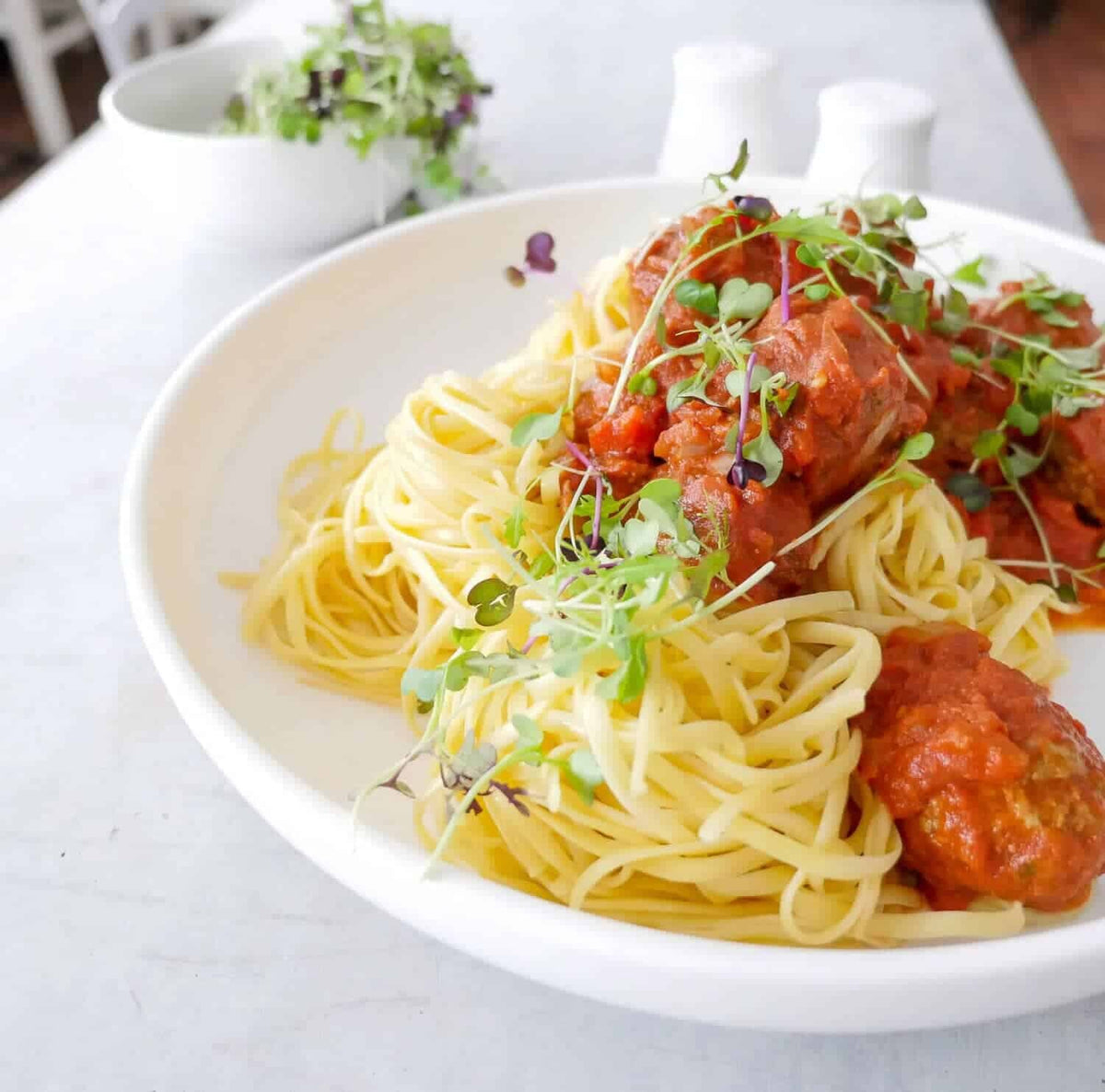 Spaghetti and meatballs topped with micro herbs, from Slow Cooker Recipes with Thermomix-Prep Options