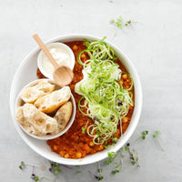 Bowl of slow cooked stew with dumplings and courgette noodles, from Slow Cooker Recipes with Thermomix-Prep Options