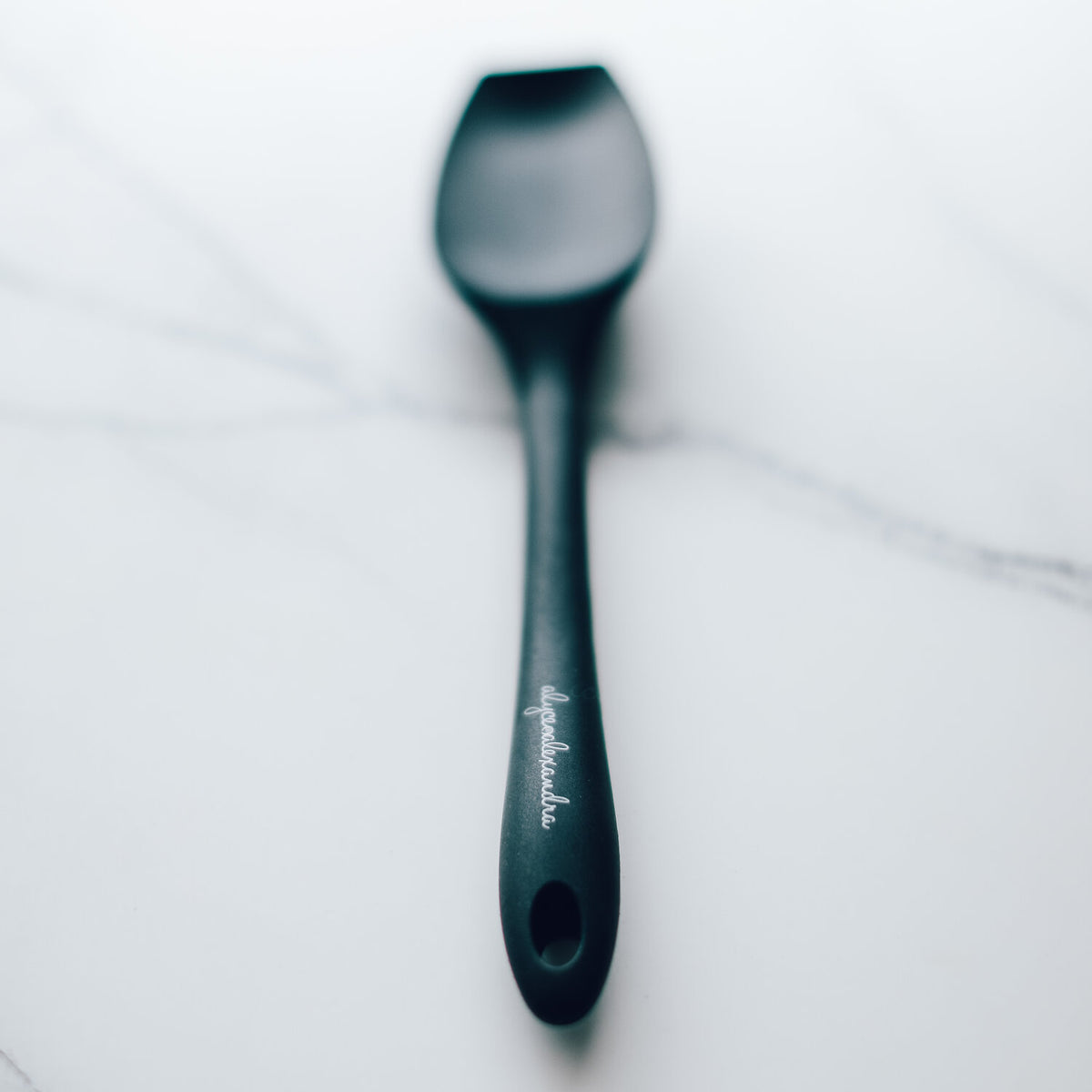 Charcoal Slow Cooker Spatula laid on white marble
