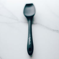 Charcoal Slow Cooker Spatula laid on white marble
