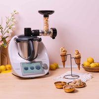 Soft-Serve Ice Cream attachment mounted on a Thermomix dispensing a swirl into a cone, with lemons and toppings alongside