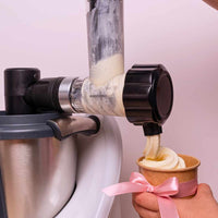 Close-up of soft serve being dispensed from the attachment into a waffle cone