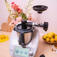 Soft-Serve Ice Cream attachment on a Thermomix in a styled kitchen with flowers and a bowl of lemons
