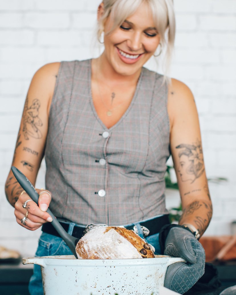 Ellen shaping a sourdough loaf of bread in a baking dish at the bench
