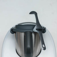 Tastix tasting spoon resting in the rim of a Thermomix mixing bowl