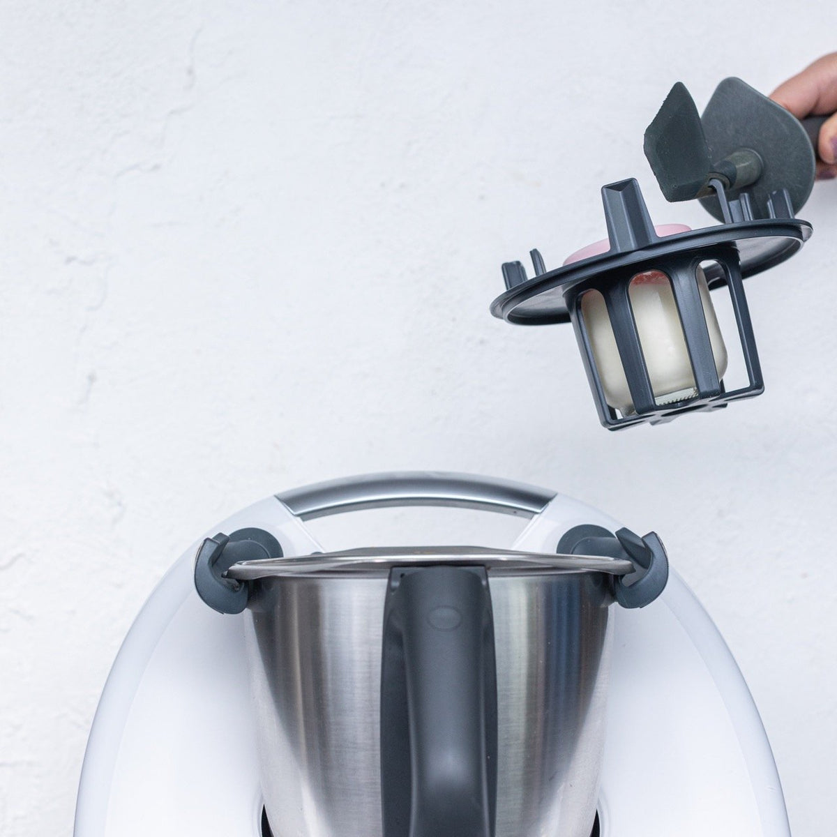 Hand fitting the Thermo Baby Bottle Warmer into the Thermomix mixing bowl