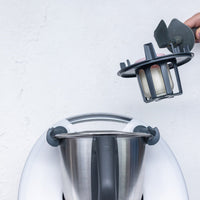 Hand fitting the Thermo Baby Bottle Warmer into the Thermomix mixing bowl