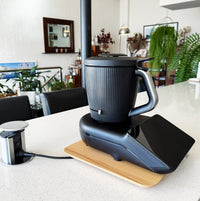 Dark Thermomix model sitting on the Thermo Deluxe Slide Board