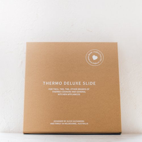 Thermo Deluxe Slide Board in its kraft gift box, shown from above