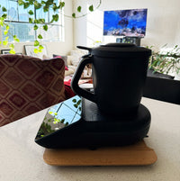 Dark Thermomix on the Thermo Deluxe Slide Board in a living space