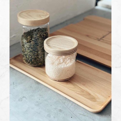 Thermo Deluxe Slide Board holding glass storage jars of grains and flour