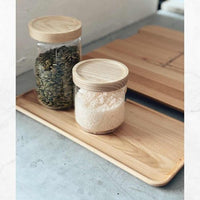 Thermo Deluxe Slide Board holding glass storage jars of grains and flour