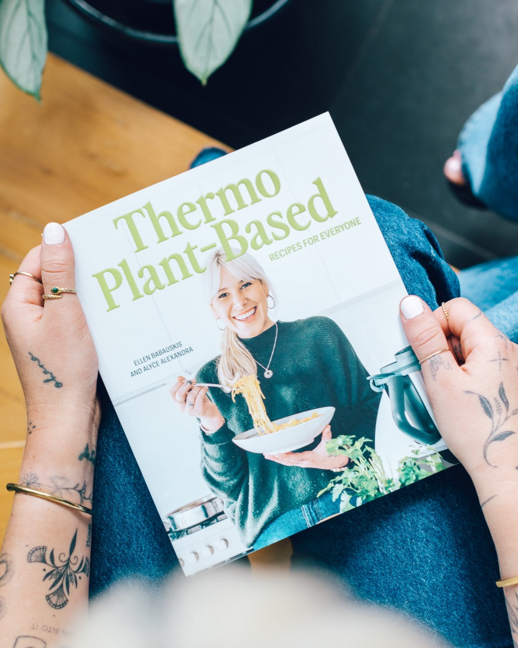 Person sitting with a copy of Thermo Plant-Based on their lap