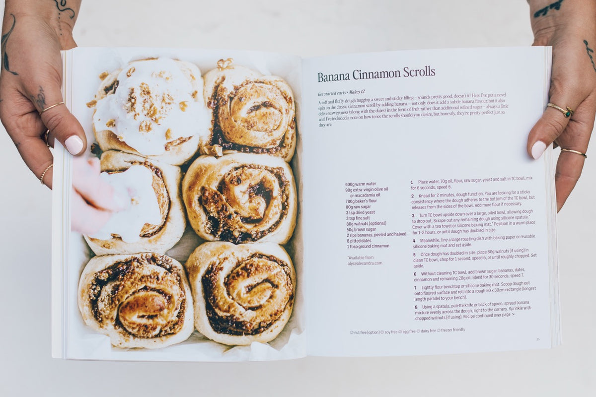 Thermo Plant-Based open at the Basic Cinnamon Scroll recipe beside a tray of scrolls