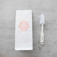 TM Blade Brush beside its cotton storage pouch
