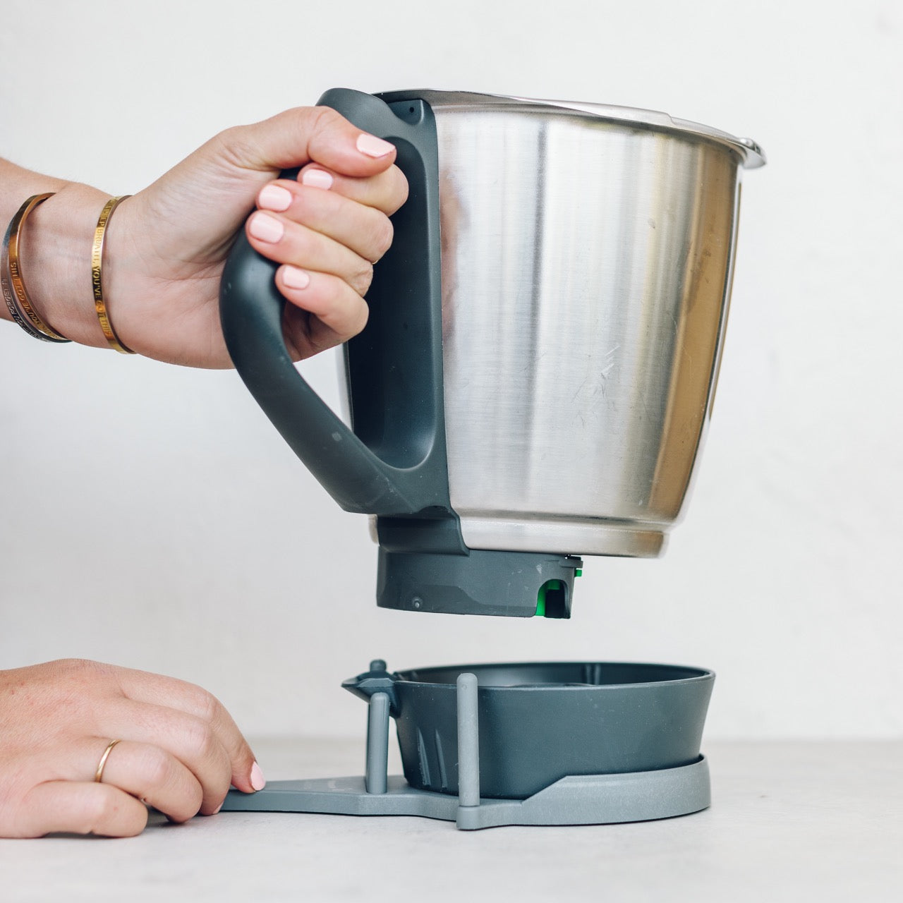 Hand using the TM Twister to open the base of a Thermomix mixing bowl