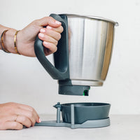 Hand using the TM Twister to open the base of a Thermomix mixing bowl