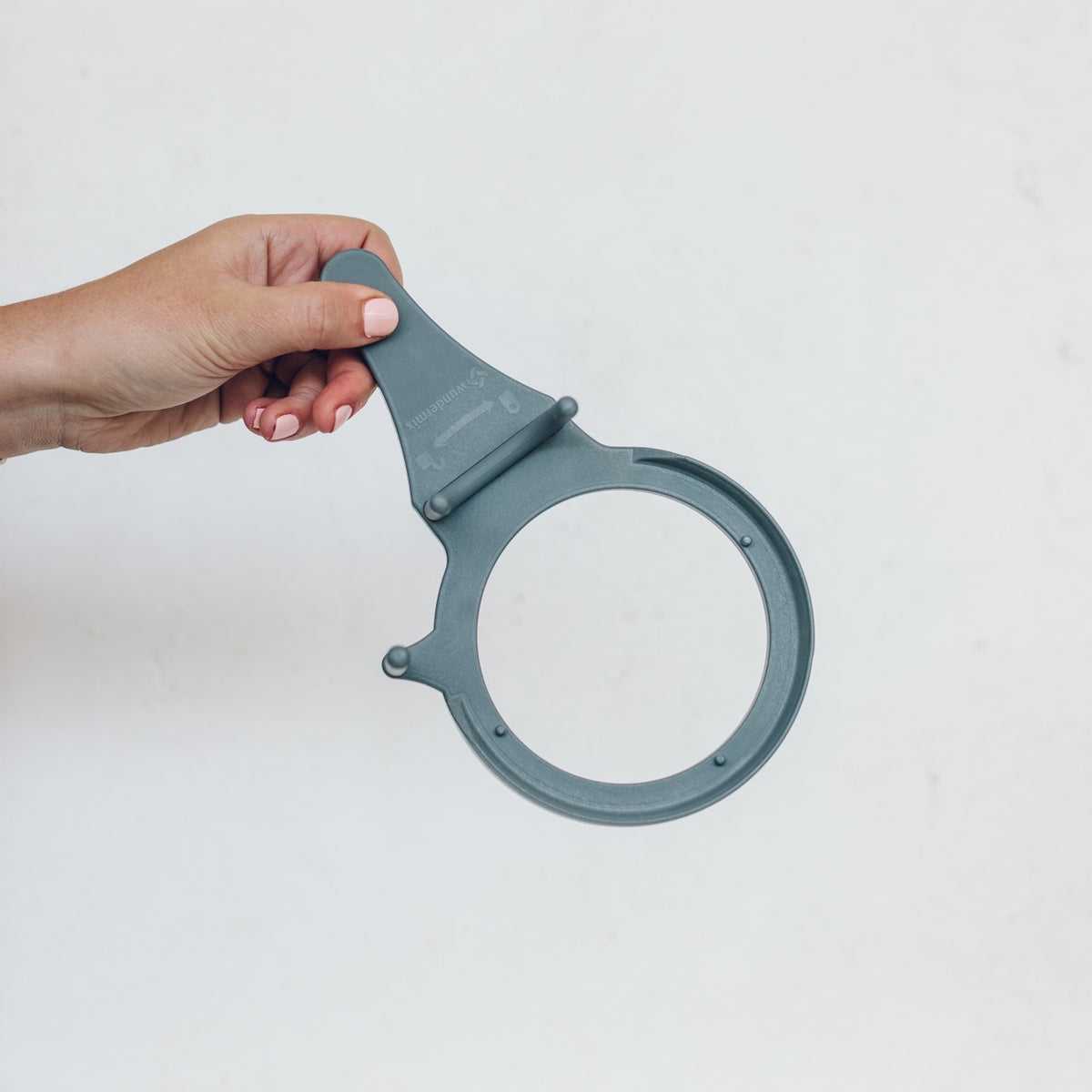 Hand holding the TM Twister, a moulded ring with a lever handle